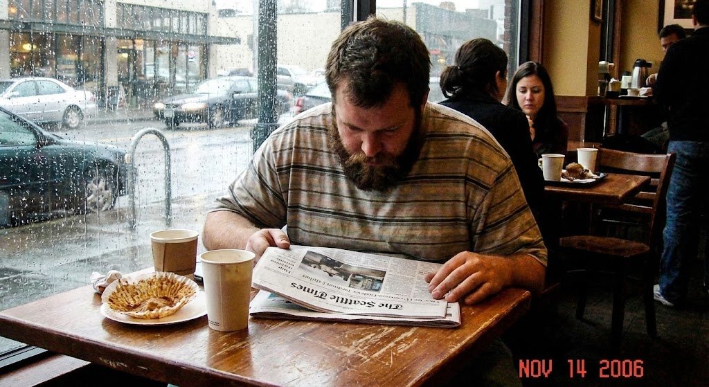 Seattle Coffee Shop A candid digital photo from 2006 shows a man with a beard...